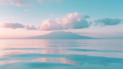 Obraz premium A peaceful sea view at sunrise with clouds and distant mountain in the background.