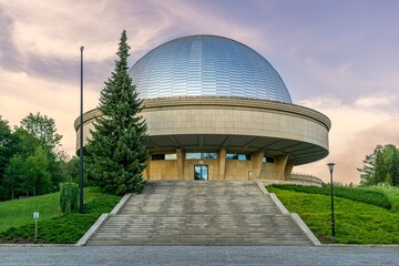 Modern dome building under twilight sky. © Wirestock
