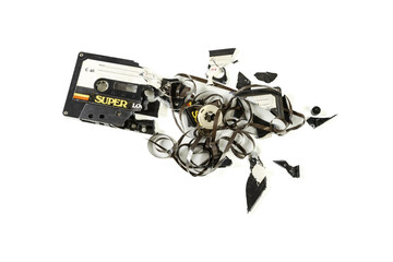 Destroyed vintage audio cassette isolated on white background