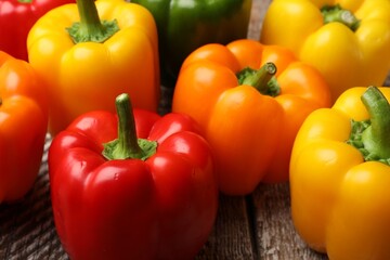 Fresh colorful bell peppers on table, closeup