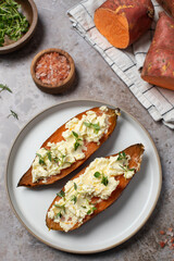 Baked sweet potatoes with ricotta and fresh herbs. Healthy and vegan food