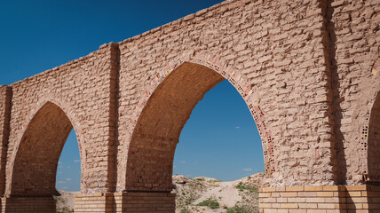 Historical architecture showcases arches in Samarra Iraq under clear blue sky