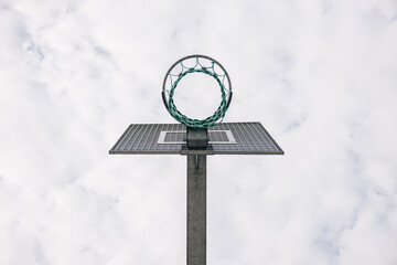 Basketball hoop standing tall against cloudy sky