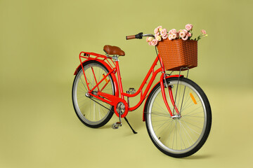 Bicycle with basket of beautiful flowers on green background