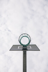 Basketball hoop standing tall against a cloudy sky