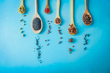 Scattered cardamom, black sesame, pink pepper, Sichuan pepper, star anise and cloves fall beneath...