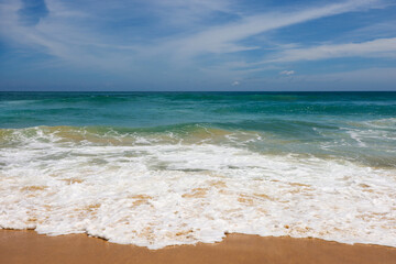 Foamy waves of sea sandy beach, surf on empty coast