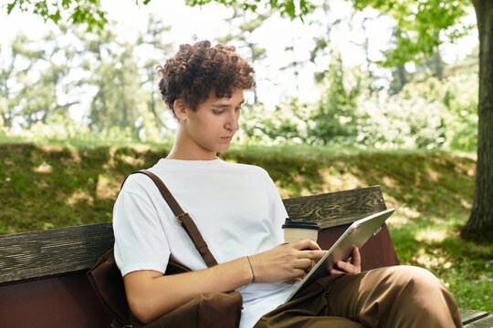 Young man enjoying a sunny afternoon in a vibrant summer park setting