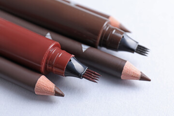 Different eyebrow pencils on white background, closeup