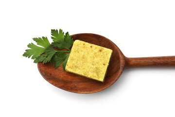 Aromatic bouillon cube, parsley and wooden spoon isolated on white, top view