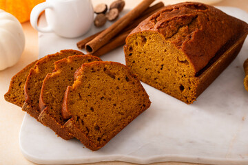 Pumpkin bread freshly baked and sliced on a serving board