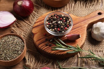 Different aromatic spices on wooden table, closeup
