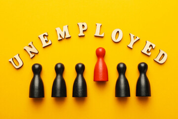Word Unemployed and human figures on yellow background, flat lay