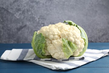 Whole raw cauliflower on blue wooden table