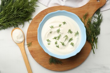 Tasty sour cream and dill on white table, flat lay