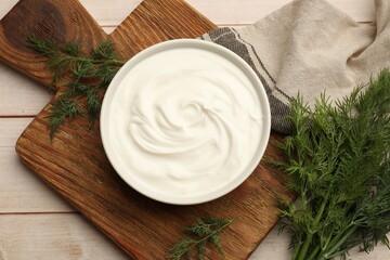 Tasty sour cream and dill on white wooden table, flat lay