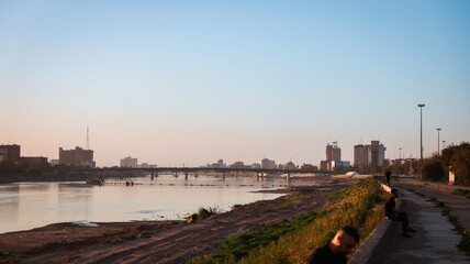 Evening view of the Tigris River with people relaxing along the waterfront in Baghdad Iraq