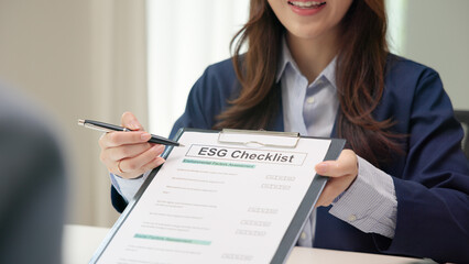 Asian female audit ESG risk check list paper form net zero waste supply chain vendor eco go green...