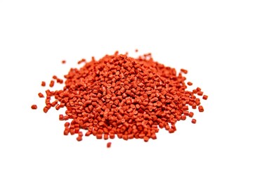 Red plastic polymer granules isolated on white