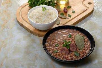  beans with sausage in a black bowl