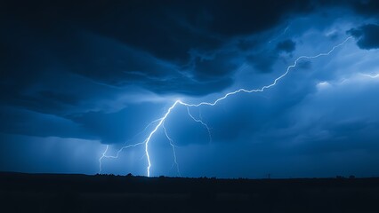 A dramatic lightning strike illuminates the dark stormy sky with electric blue brilliance.