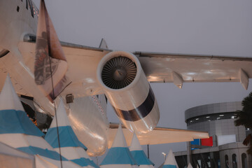 An Airplane Wing and Jet Engine stand out against colorful Festival Tents, creating a lively scene