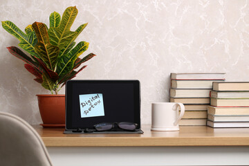 Digital detox reminder on tablet with books and plant promoting relaxation and mindfulness