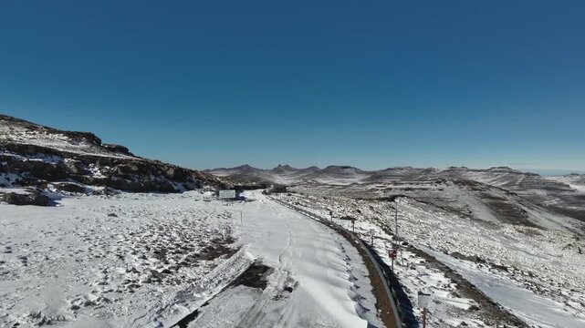 Frozen Passage: Remote Road in Snow-Covered Lesotho Highlands.