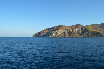 Rocky Island Coastline with Deep Blue Sea and Clear Sky