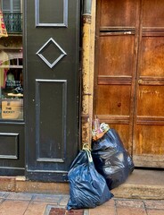 Urban Trash Bags Against Old Wooden and Painted Doors