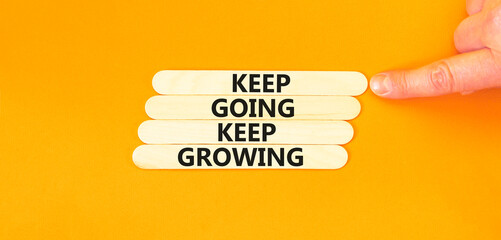 Keep going and growing symbol. Concept words phrase Keep going keep growing on beautiful wooden...