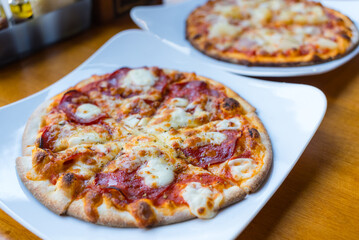 Delicious pizza with toppings served at restaurant table