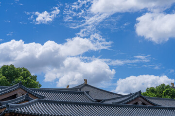 Blue sky and white clouds on the roof of ancient building