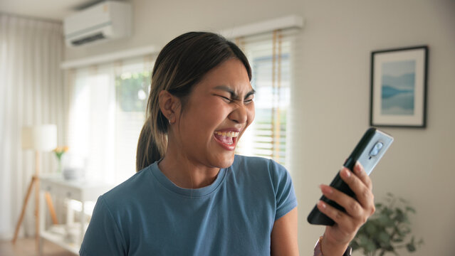 Asia young adult black people humor bizarre funny dance good news at home living room happy joy job hired interview result on mobile, award bonus, win luck bet online game order trade, loan money. - Powered by Adobe