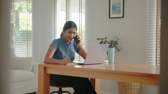 Young adult Gen Z people black asia woman busy phone call work at home using laptop AI search data hybrid workplace. Stock trade IT reskill upskill asian cyber typing coding. Online income tax apply