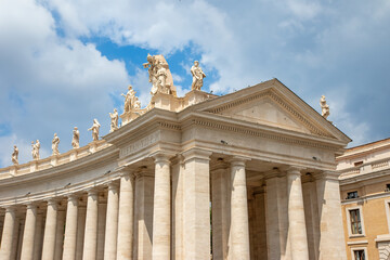 Colonnade of St. Peter’s Square with blue sky with clouds on the background. Vatican. Italy....