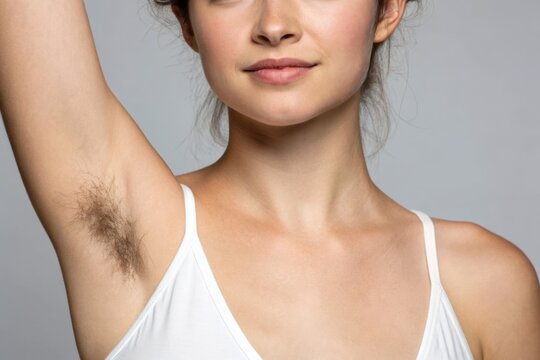 A woman displays her unshaven armpit, promoting body positivity and natural beauty in a contemporary setting. - Powered by Adobe