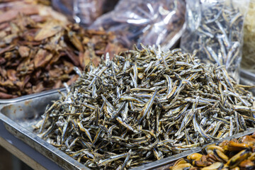 Vendor selling dried fish at local market