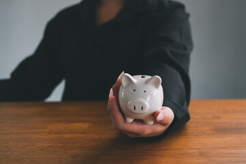  saving with growing your money to real estate owner in the future concept.Close up of stacking money coins and piggy bank.