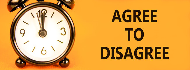 Agree to disagree symbol. Concept words Agree to disagree on beautiful orange paper. Alarm clock....