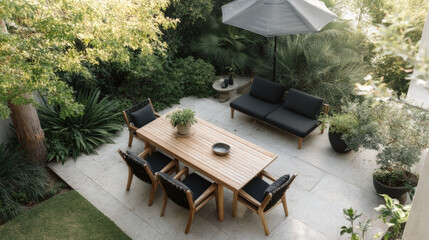 Stylish garden patio with wooden table, black cushioned chairs, and lush green plants