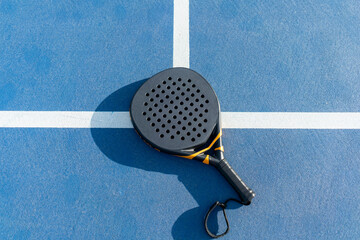 High-angle view of padel tennis racket on court surface