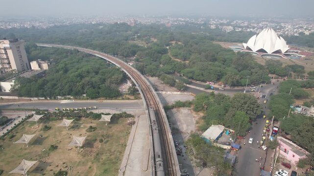 Aerial Drone footage of Delhi metro train near Lotus Temple in New delhi India