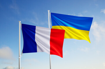 flags of ukraine and french over blue sky background.