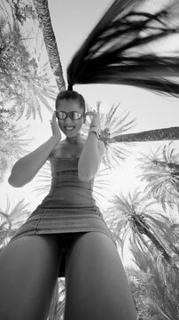 Chic and Stylish Outdoor Portrait Featuring Beautiful Palm Trees in Elegant Black and White