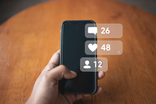 Social Media Engagement Concept A Hand Holding a Smartphone Displaying Notifications for Comments Likes and Followers Representing Online Interaction and Growth