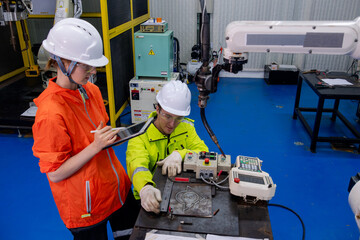 Young student engages with instructor during robotics training in a modern workshop setting in the afternoon
