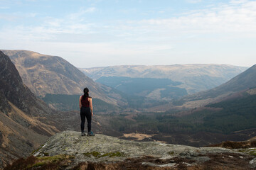 Woman looks out at the view, Corrie Fee, Glen Clova, Scotland. 