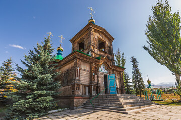 Ancient wooden church in Karakol, Kyrgyzstan.  Orthodox architecture, intricate carvings, and...