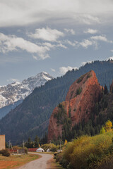 Scenic autumn landscape in the Charyn Canyon, Kazakhstan. A winding road leads towards a yurt,...